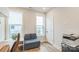 Bright office space with a cozy loveseat, two windows, and light wood flooring at 3105 Beans Blvd, Charlotte, NC 28203