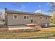 Back of house featuring a small deck, light siding, a grassy yard, and landscaping at 3205 19Th Ne Ave, Hickory, NC 28601