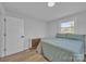 Cozy bedroom with light walls, a natural light window, and modern wood-look flooring at 3205 19Th Ne Ave, Hickory, NC 28601