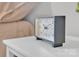 Close-up of a modern clock sitting on a white nightstand in a neutrally designed bedroom at 3205 19Th Ne Ave, Hickory, NC 28601