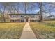 Charming home with neutral siding, brick foundation, well-manicured lawn and sidewalk at 3205 19Th Ne Ave, Hickory, NC 28601