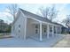 Inviting exterior view of a single-story home featuring a cozy front porch with white columns at 333 City Ave, Lancaster, SC 29720