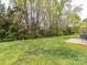 Sprawling backyard with lush greenery and mature trees at 3721 Oak View Ct, Matthews, NC 28105