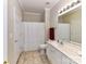 Bright bathroom featuring a single sink vanity, toilet, shower with curtain, and tiled floors at 3721 Oak View Ct, Matthews, NC 28105