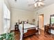 Charming bedroom with a four-poster bed, hardwood floors, and a ceiling fan for added comfort at 3721 Oak View Ct, Matthews, NC 28105