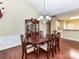 Formal dining room showcasing chandelier lighting, wooden floors, and wainscoting at 3721 Oak View Ct, Matthews, NC 28105