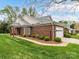 Beautiful brick home with a two-car garage, walkway, and manicured landscaping at 3721 Oak View Ct, Matthews, NC 28105