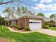 Charming brick home featuring a two-car garage and meticulously maintained landscaping at 3721 Oak View Ct, Matthews, NC 28105