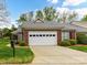 Brick home featuring a two-car garage with lush green grass and landscaping around the property at 3721 Oak View Ct, Matthews, NC 28105