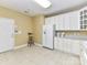 Charming eat-in kitchen boasts white cabinets and lots of counter space at 3721 Oak View Ct, Matthews, NC 28105