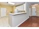 Open kitchen with white cabinetry, breakfast bar, and easy access to the front entrance at 3721 Oak View Ct, Matthews, NC 28105