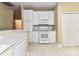 Well-lit kitchen featuring white appliances and cabinetry, tile floors, and ample counter space at 3721 Oak View Ct, Matthews, NC 28105