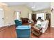 Open-concept living room with hardwood floors, natural light, and comfortable seating arrangement at 3721 Oak View Ct, Matthews, NC 28105