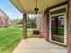 Covered outdoor patio area featuring brick columns and view of backyard at 3721 Oak View Ct, Matthews, NC 28105