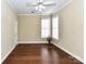 Versatile room with hardwood floors, neutral walls, and a ceiling fan at 3721 Oak View Ct, Matthews, NC 28105