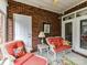 Enclosed sunroom features brick accents and cozy seating at 3721 Oak View Ct, Matthews, NC 28105