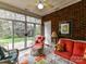 Cozy sunroom with brick accent wall, tiled floors, and a comfortable seating area at 3721 Oak View Ct, Matthews, NC 28105