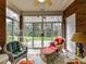 Inviting sunroom with brick walls, tiled floors, and multiple windows offering serene views of the outdoors at 3721 Oak View Ct, Matthews, NC 28105