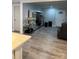 Open-concept living room features wood-look floors, a modern entertainment center, and plenty of space at 3810 W Franklin Blvd, Gastonia, NC 28052