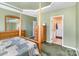 Inviting bedroom boasting a four-poster bed and dresser, flowing into an attached bathroom for convenience at 4039 Holly Villa Cir, Indian Trail, NC 28079