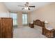 Cozy bedroom with neutral walls, complete with matching nightstands, dresser, and a ceiling fan for added comfort at 4039 Holly Villa Cir, Indian Trail, NC 28079