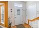 Bright entryway featuring a white door, coat hooks, and a staircase at 4039 Holly Villa Cir, Indian Trail, NC 28079