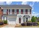 Charming townhome with a front-facing garage, complemented by lush landscaping at 4039 Holly Villa Cir, Indian Trail, NC 28079