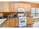 Functional kitchen with light wood cabinets and appliances, offering plenty of space at 4039 Holly Villa Cir, Indian Trail, NC 28079