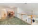 Versatile loft area with desk setup and staircase access, perfect for a home office or relaxation space at 4039 Holly Villa Cir, Indian Trail, NC 28079
