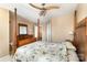 Comfortable main bedroom featuring a ceiling fan and four-poster bed, complemented by natural light at 4039 Holly Villa Cir, Indian Trail, NC 28079