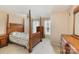 Relaxing main bedroom with four-poster bed, complemented by natural light and neutral decor at 4039 Holly Villa Cir, Indian Trail, NC 28079