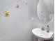 Cozy powder room featuring an oval mirror and pedestal sink, enhanced with decorative wall art at 4039 Holly Villa Cir, Indian Trail, NC 28079