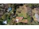 Aerial view of a well-maintained home with a sprawling yard, surrounded by lush trees at 4487 Catawba Burris Rd, Denver, NC 28037