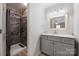 Bathroom features a stylish vanity with marble counters and a tiled shower with glass door at 4487 Catawba Burris Rd, Denver, NC 28037