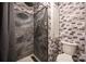This bathroom features a tiled shower with a rainfall shower head and a modern toilet at 4487 Catawba Burris Rd, Denver, NC 28037
