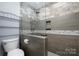 Modern bathroom with glass enclosed shower and shelving at 4487 Catawba Burris Rd, Denver, NC 28037