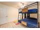 A blue bunk bed sits on a wood-look floor with a ceiling fan in the bedroom at 4487 Catawba Burris Rd, Denver, NC 28037