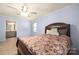 This bedroom features a ceiling fan, wood-look floors, and good natural light at 4487 Catawba Burris Rd, Denver, NC 28037