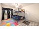 The bedroom has a ceiling fan, wood-look floors, and a blue bunk bed at 4487 Catawba Burris Rd, Denver, NC 28037