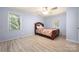 Cozy bedroom with natural light, ceiling fan, and wood-look floors at 4487 Catawba Burris Rd, Denver, NC 28037