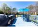Outdoor deck with a blue finish, a blue table, and a blue umbrella, great for relaxing outdoors at 4487 Catawba Burris Rd, Denver, NC 28037