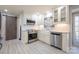 Bright kitchen with white cabinets, stainless steel appliances, and a farmhouse sink, blending style and functionality at 4487 Catawba Burris Rd, Denver, NC 28037
