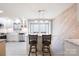 Bright kitchen features white cabinets, granite countertops, stainless steel appliances, and breakfast bar at 4487 Catawba Burris Rd, Denver, NC 28037