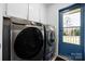 Updated laundry room equipped with modern, stainless-steel front loading washer and dryer at 4487 Catawba Burris Rd, Denver, NC 28037