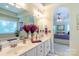 Bathroom boasts double sinks, ample vanity storage space, and an open doorway leading to the bedroom at 4586 Chanel Ct, Concord, NC 28025