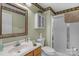 Bathroom featuring a vanity sink, toilet and walk in shower; with decorative border at 4586 Chanel Ct, Concord, NC 28025