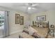 Comfortable bedroom featuring a decorative ceiling fan and a cozy bench at the foot of the bed at 4586 Chanel Ct, Concord, NC 28025