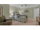 Comfortable bedroom with neutral walls, a ceiling fan, and decorative wall art at 4586 Chanel Ct, Concord, NC 28025