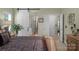 Comfortable bedroom features a sliding barn door leading to the bathroom and is decorated with fresh plants at 4586 Chanel Ct, Concord, NC 28025