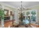 Elegant dining room featuring a glass table, chandelier, and natural light at 4586 Chanel Ct, Concord, NC 28025